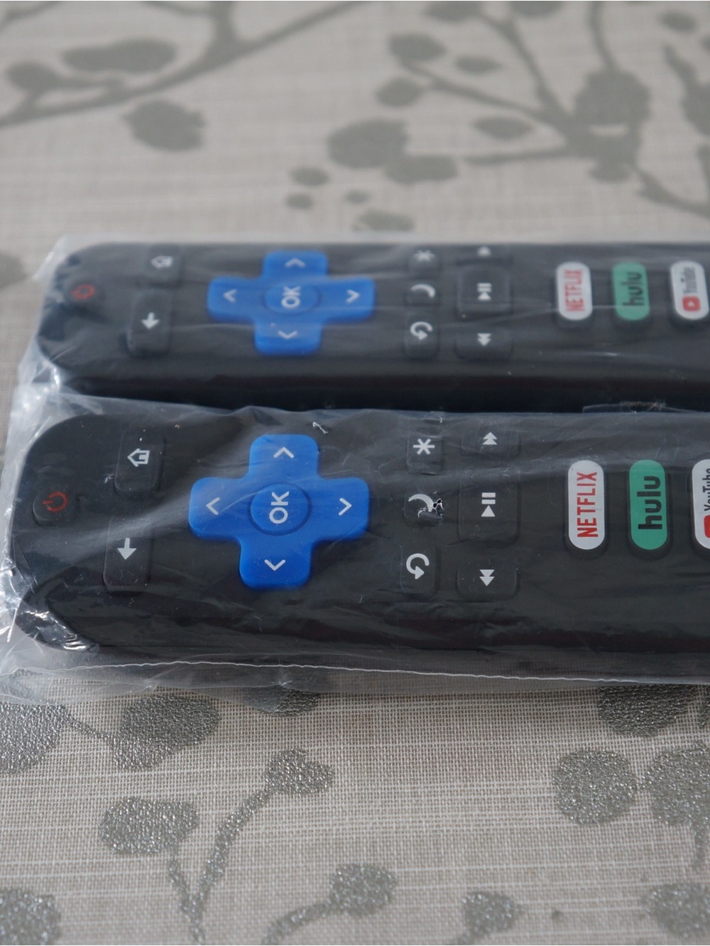 Black TV Remote with Blue Directional Pad and Streaming Buttons